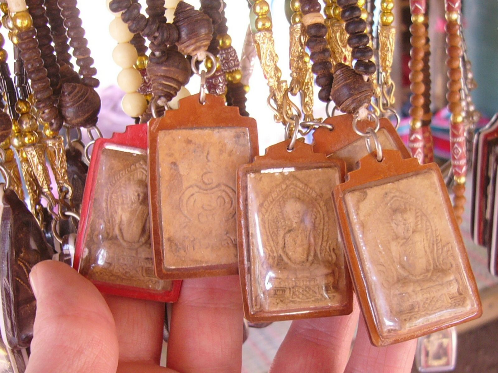Thai Buddhist amulets hanging with prayer beads